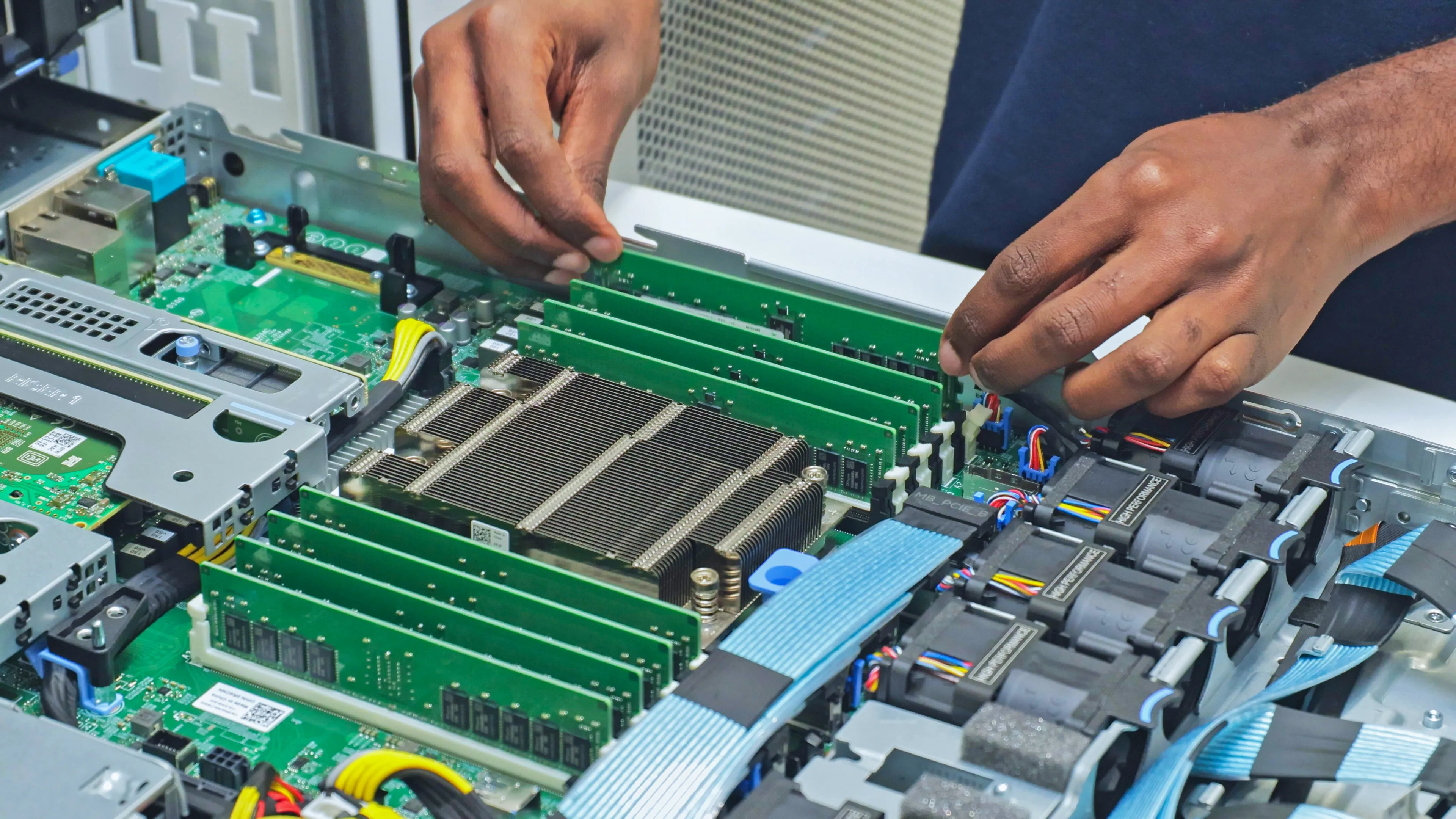 DACPROS engineer carefully installing RAM modules into an open server — the precision skills that prevent costly mistakes.